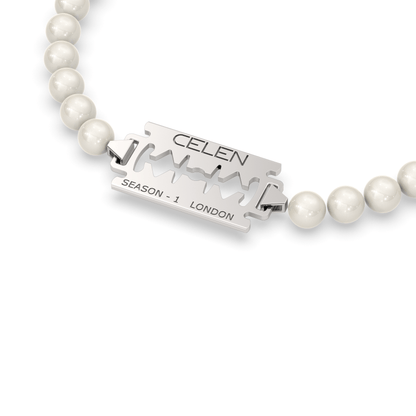 Razor blade pendant necklace and bracelet set adorned with synthetic pearls and stainless steel beads.